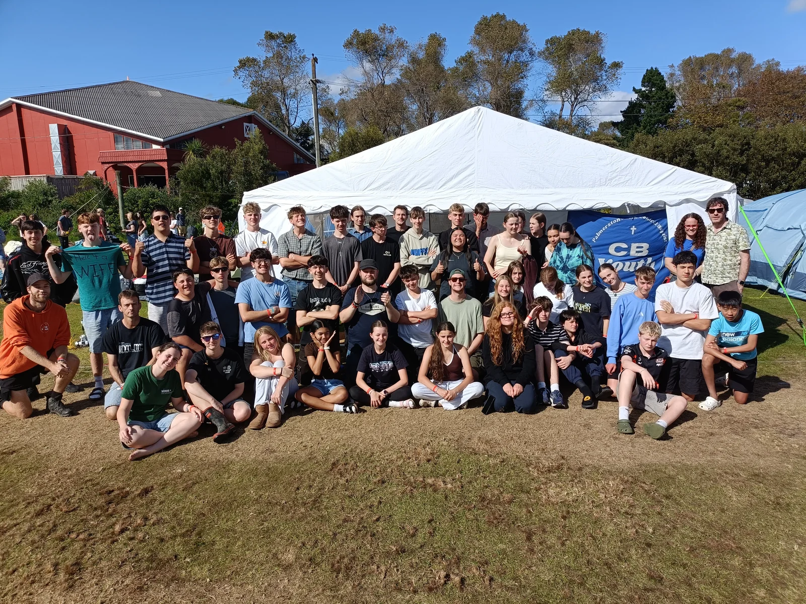 CB Youth group gathered outdoors in front of their tent